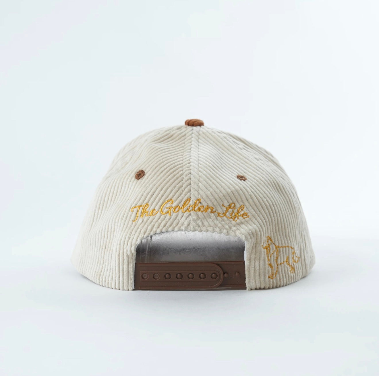 Back view of embroidered corduroy snapback hat with adjustable closure, “The Golden Life” stitching, and golden retriever embroidery on the side