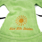 Close-up of light green corduroy dog hat showing embroidered yellow sunburst and “Live Life Golden” text — The Golden Life Key Lime Fisherman collection.