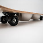 The Golden Life Kickflip Kibble Board dog feeder shaped like a skateboard with two stainless steel bowls, white board design with teal and orange racing stripes, and fixed black wheels. Get your Skateboard Dog Bowl today!