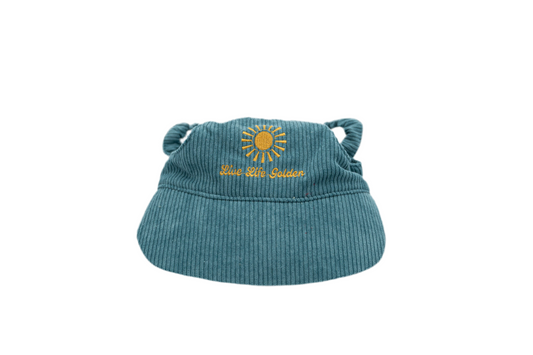Blue corduroy dog hat with golden sunburst and ‘Live Life Golden’ embroidery from The Golden Life.