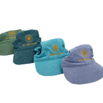 Angled view of corduroy dog hats with bills in green, teal, blue, and purple, embroidered with Live Life Golden sunburst.