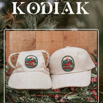 Cream corduroy human and dog hat set featuring The Kodiak adventure paddleboard iron on patch with a golden retriever, mountains, sun, and water design.