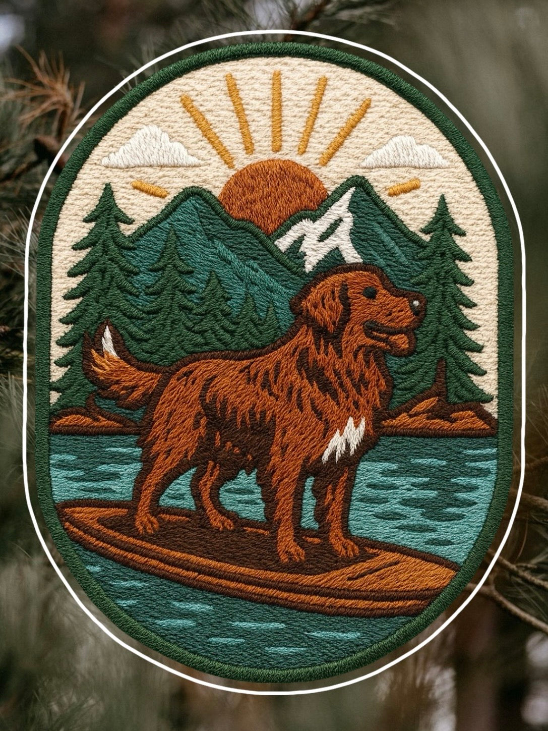 Embroidered adventure iron on patch featuring a golden retriever paddleboarding on calm water with mountains and sunrise in the background.