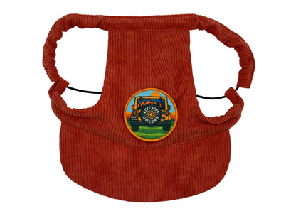 Rust-red corduroy dog hat featuring a “Live Life Golden” Jeep patch — designed with adjustable straps, a curved brim, and soft corduroy texture from The Golden Life Golden Gala collection.