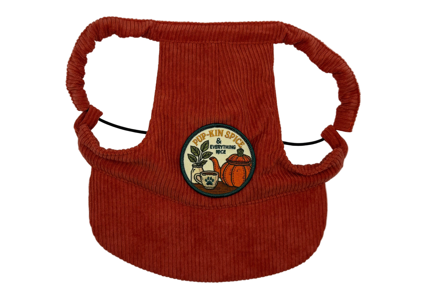 Rust-red corduroy dog hat featuring a “Pup-kin Spice & Everything Nice” patch with pumpkin and coffee cup design — cozy autumn vibes meet playful pup style. Adjustable straps, curved brim, and soft corduroy texture from The Golden Life Golden Gala collection.
